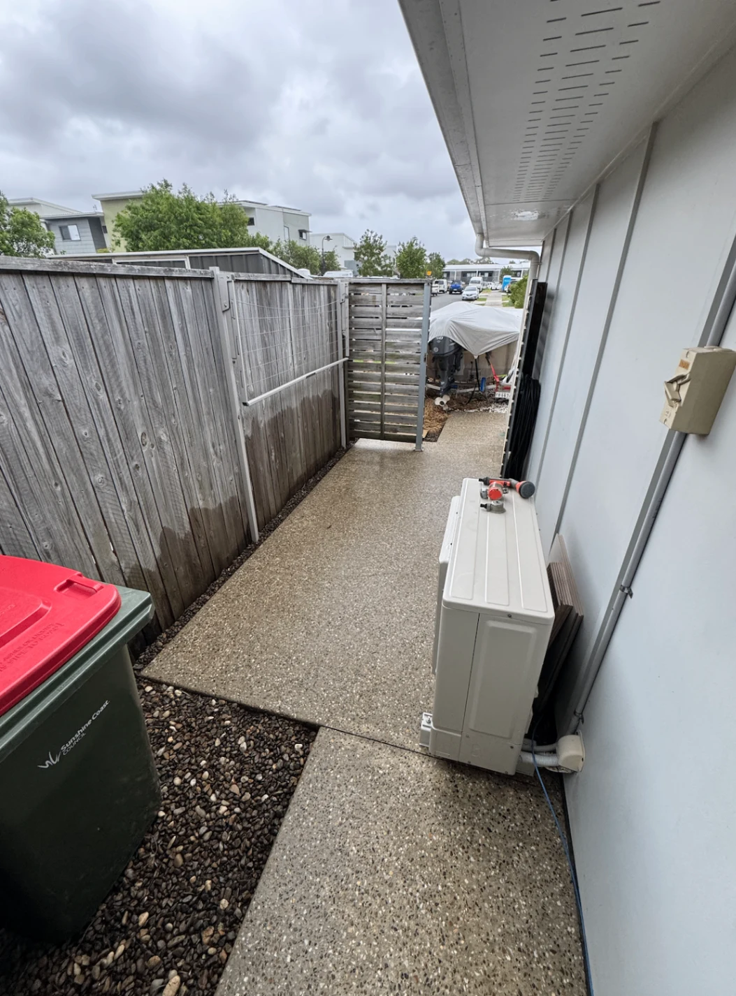 Clean concrete side path alongside a timber fence